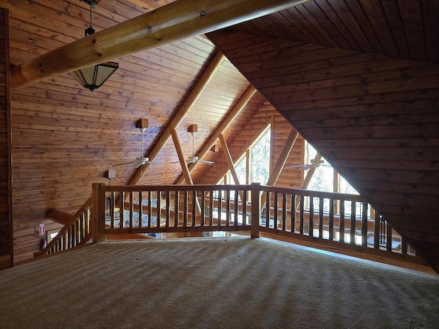 bonus room with wood ceiling, wood walls, lofted ceiling with beams, and carpet floors
