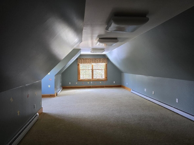 additional living space with lofted ceiling, carpet flooring, and a baseboard heating unit