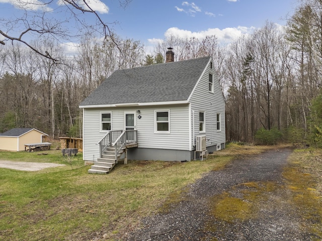 155 Saco Rd, Hollis, ME 04042 - view of front of house featuring a chimney, roof with shingles, and a front lawn