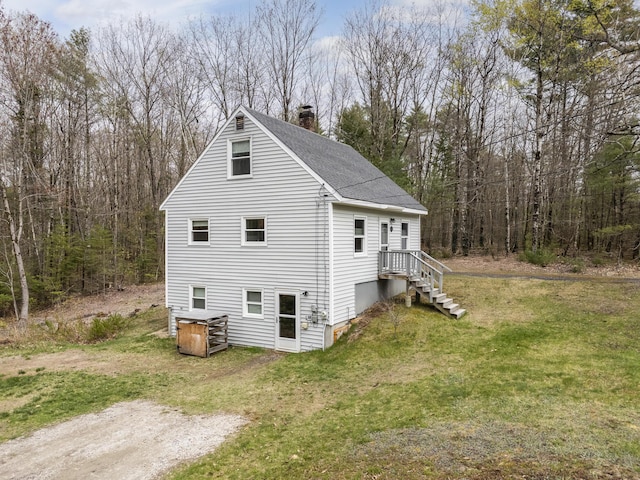 155 Saco Rd, Hollis, ME 04042 - view of property exterior featuring roof with shingles, a lawn, and a chimney
