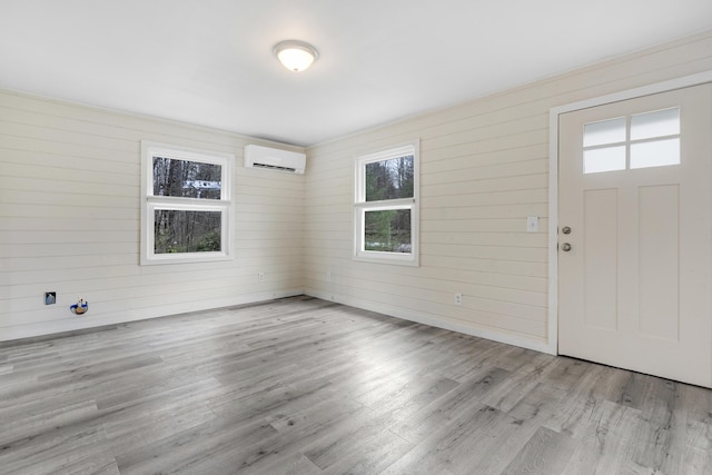 155 Saco Rd, Hollis, ME 04042 - entrance foyer with a wall unit AC, wood finished floors, and wooden walls