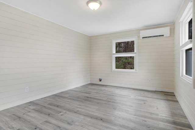 155 Saco Rd, Hollis, ME 04042 - unfurnished room featuring a wall unit AC, wood finished floors, and wooden walls