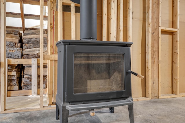 155 Saco Rd, Hollis, ME 04042 - detailed view of unfinished concrete flooring and a wood stove