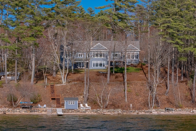 exterior space featuring stairs and a water view