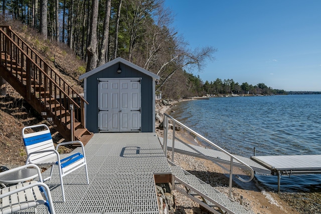 dock area with stairs and a water view
