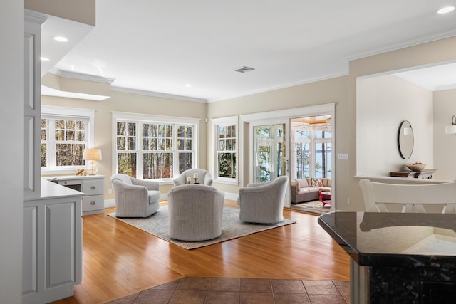 living room with light tile patterned floors, visible vents, recessed lighting, and ornamental molding