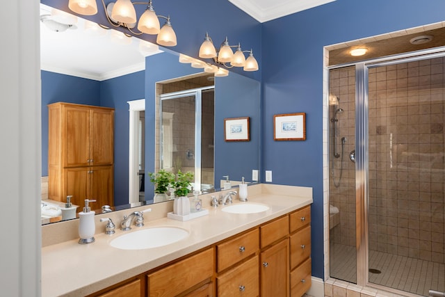 bathroom with a stall shower, ornamental molding, double vanity, and a sink