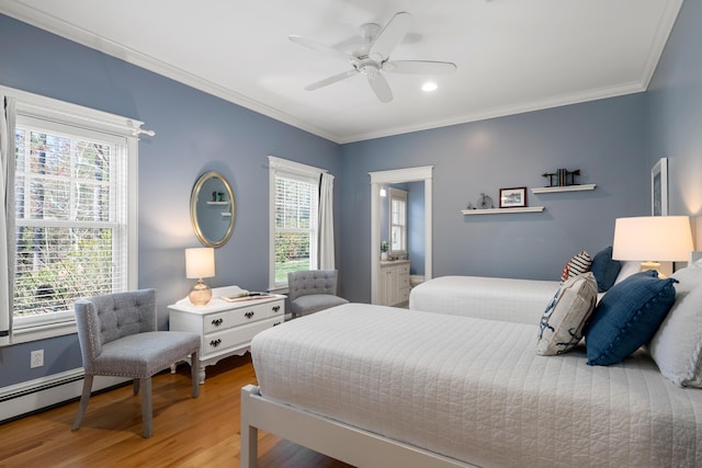 bedroom featuring crown molding, multiple windows, and light wood-style flooring