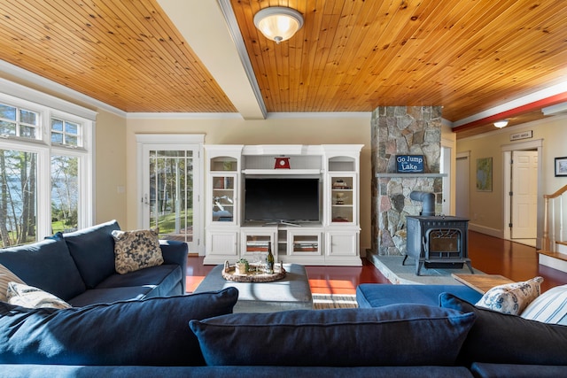 living room featuring wood finished floors, a wood stove, and wooden ceiling