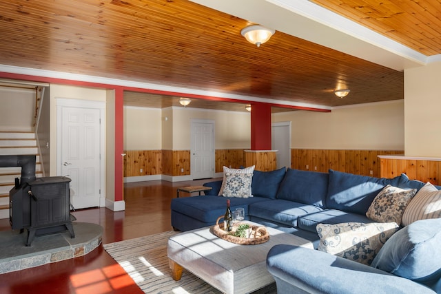 living room with wooden walls, stairs, wooden ceiling, and wainscoting