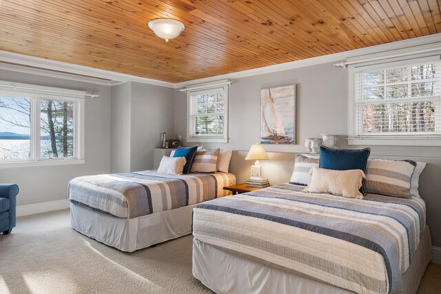 carpeted bedroom with crown molding, multiple windows, and wood ceiling