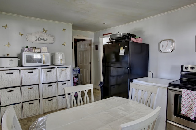 kitchen with ornamental molding, white microwave, freestanding refrigerator, and electric stove