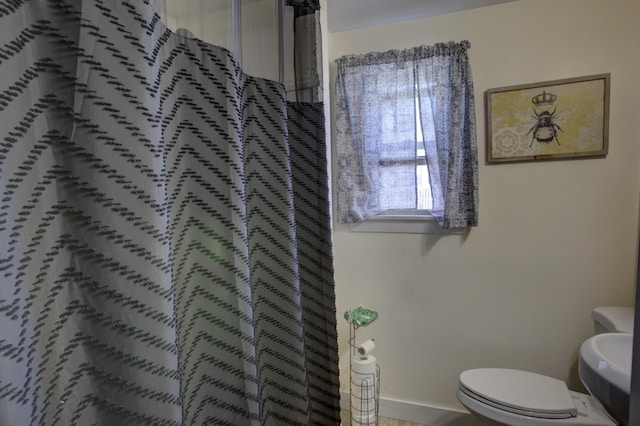 full bath with a shower with curtain and toilet