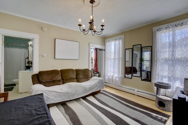 living room featuring an inviting chandelier, a baseboard radiator, crown molding, and wood finished floors