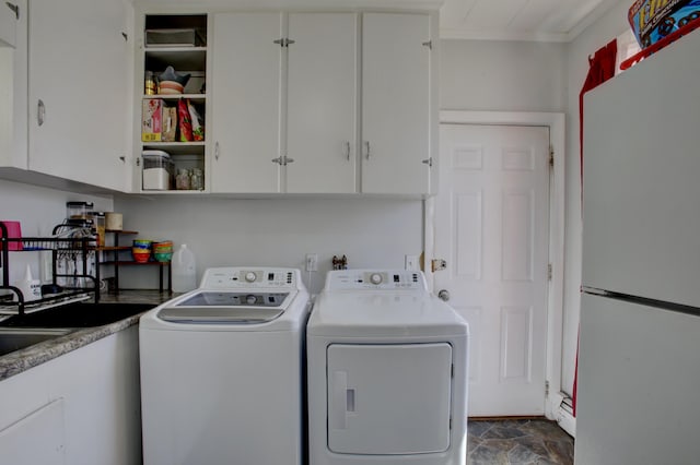 laundry area with cabinet space, a baseboard heating unit, stone finish floor, and washing machine and clothes dryer