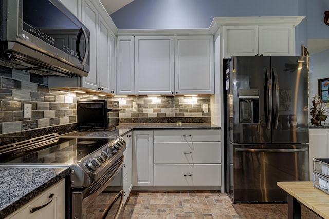 kitchen featuring black appliances, white cabinets, and backsplash
