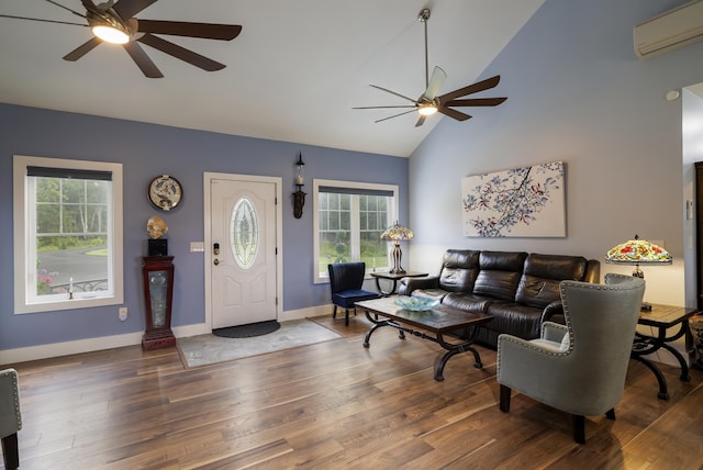 living room with wood finished floors, plenty of natural light, a ceiling fan, and a wall mounted AC