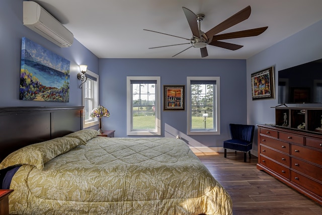 bedroom with dark wood-style flooring, a wall mounted air conditioner, a ceiling fan, and baseboards