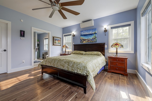 bedroom featuring wood finished floors, a ceiling fan, an AC wall unit, and baseboards