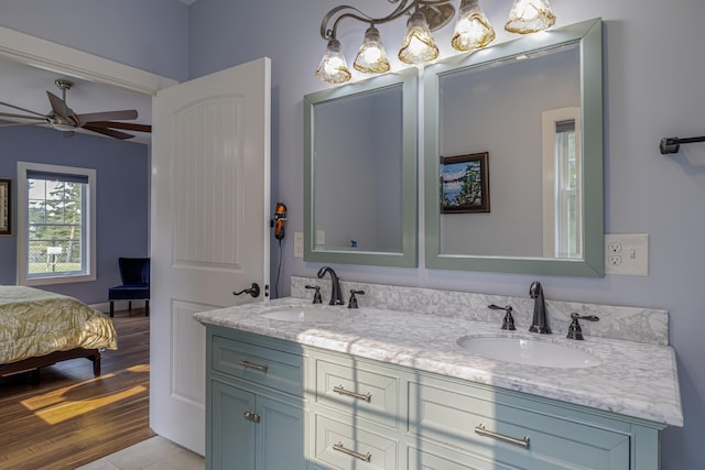 full bathroom featuring double vanity, connected bathroom, a ceiling fan, and a sink