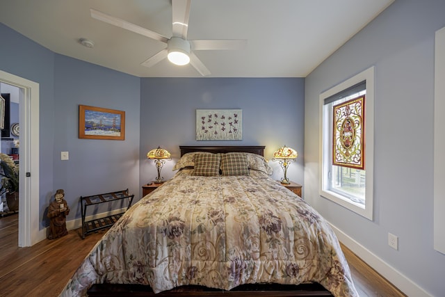bedroom featuring ceiling fan, baseboards, and dark wood-type flooring