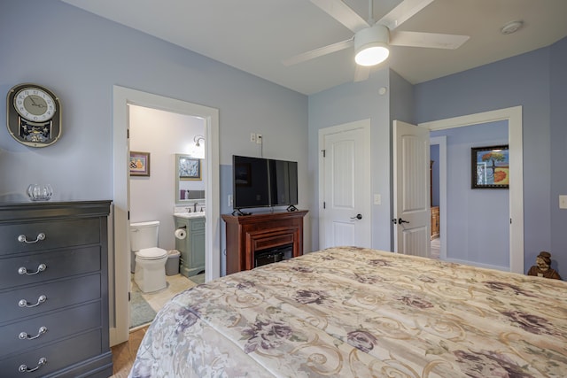bedroom with a ceiling fan and ensuite bath