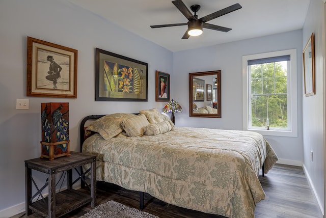 bedroom with wood finished floors, ceiling fan, and baseboards