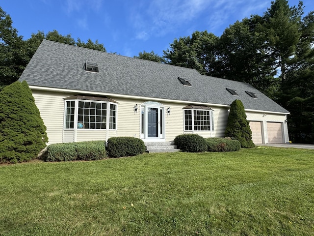 cape cod-style house featuring a garage, a front lawn, concrete driveway, and roof with shingles
