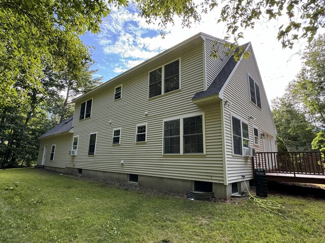 rear view of house with a wooden deck, a shingled roof, and a yard