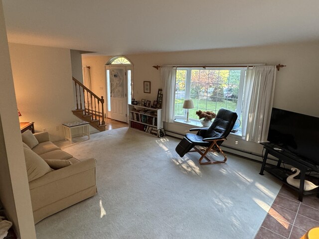 living area featuring stairway, tile patterned flooring, carpet, and a baseboard radiator