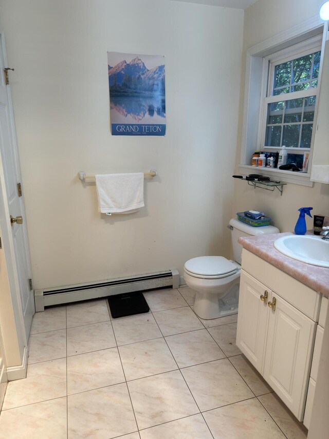bathroom featuring tile patterned floors, vanity, toilet, and a baseboard heating unit