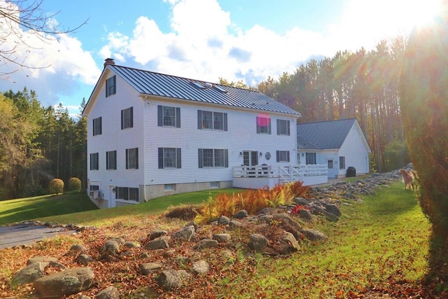 2101 Ohio St, Bangor, ME 04401 - rear view of property with a standing seam roof, metal roof, a lawn, a chimney, and a deck