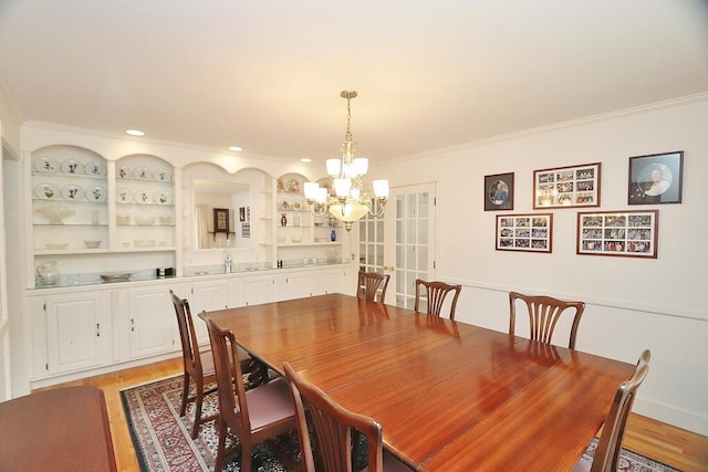 2101 Ohio St, Bangor, ME 04401 - dining area with light wood-style floors, crown molding, and a notable chandelier