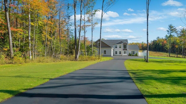 view of front of property with driveway and a front yard