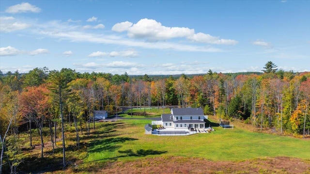 birds eye view of property with a view of trees