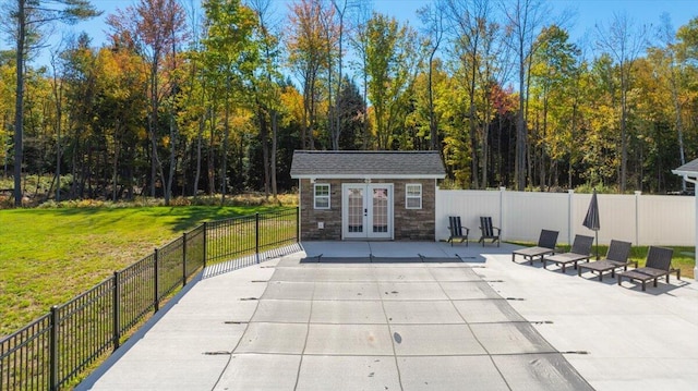 exterior space with an outdoor structure, fence, and french doors