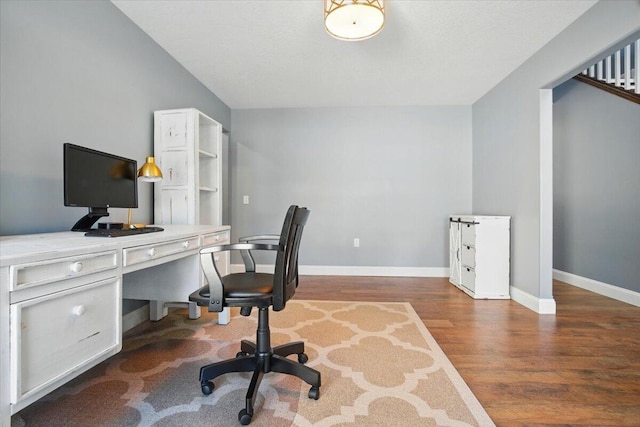 home office with baseboards and wood finished floors