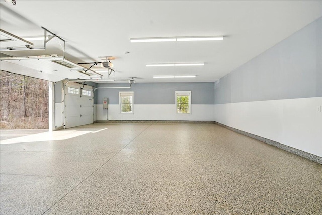 garage with baseboards and a garage door opener