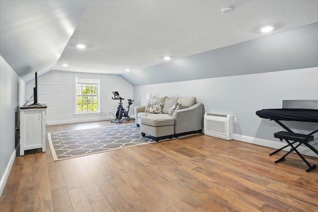 sitting room with baseboards, vaulted ceiling, recessed lighting, and hardwood / wood-style floors