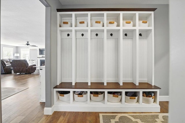 mudroom with a ceiling fan and wood finished floors