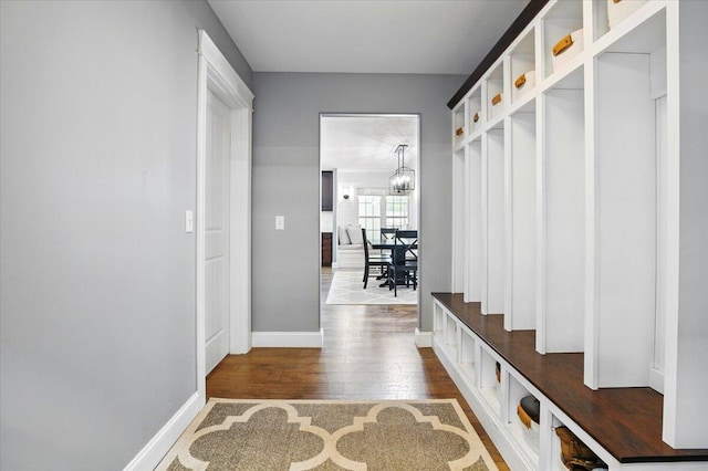 mudroom with baseboards and dark wood-style floors