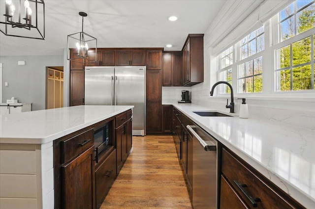 kitchen with stainless steel appliances, a chandelier, recessed lighting, and light wood-type flooring