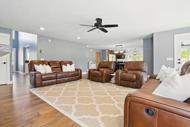 living area featuring baseboards, recessed lighting, ceiling fan, and wood finished floors