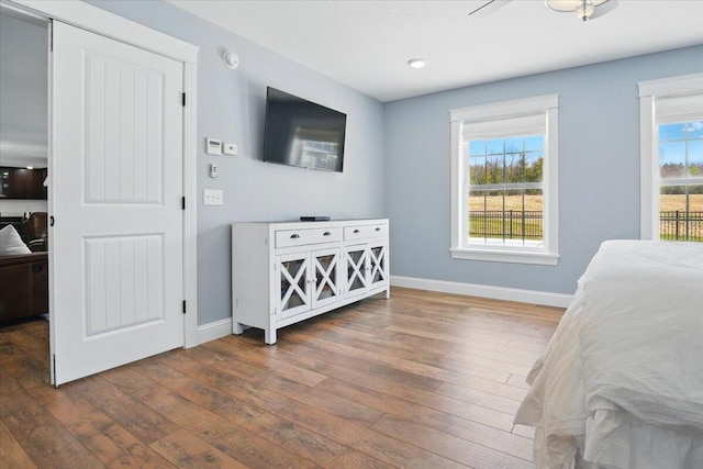 bedroom with baseboards, recessed lighting, and hardwood / wood-style floors