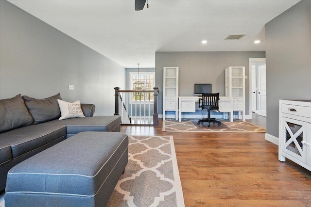 living area featuring visible vents, wood finished floors, baseboards, recessed lighting, and a ceiling fan