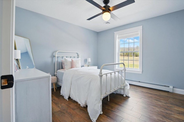 bedroom featuring ceiling fan, baseboards, a baseboard radiator, visible vents, and hardwood / wood-style flooring