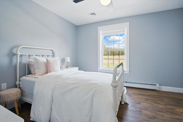 bedroom featuring visible vents, wood finished floors, baseboards, ceiling fan, and a baseboard radiator