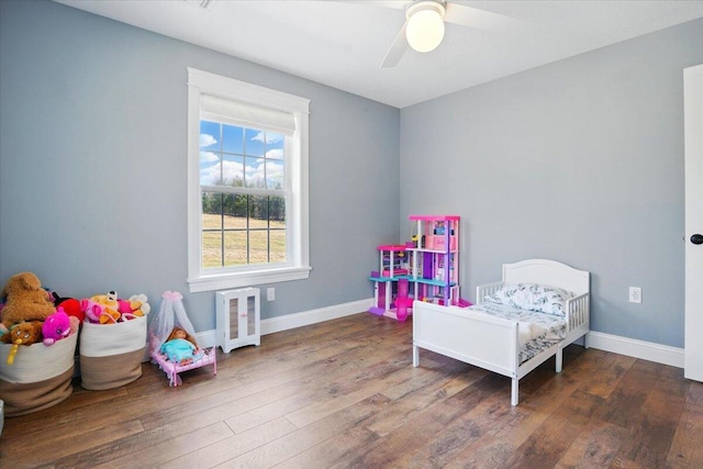 bedroom with baseboards, a ceiling fan, and wood finished floors