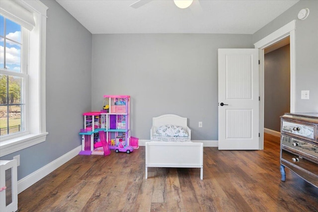 playroom featuring baseboards, ceiling fan, and wood finished floors