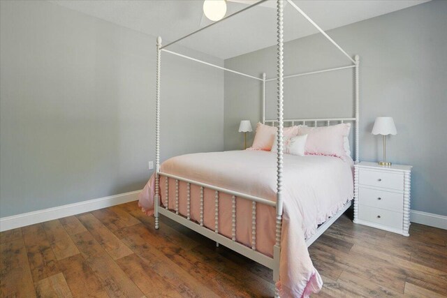 bedroom featuring baseboards and hardwood / wood-style flooring